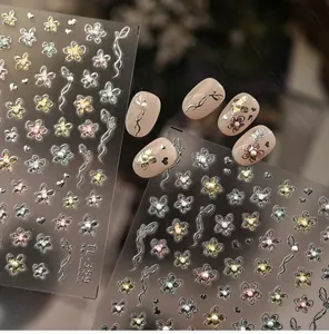 Close-up of floral embossed nail stickers with delicate pearls and elegant bow designs