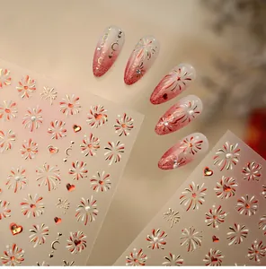 Detail of New Year nail stickers featuring gold foil fireworks and red heart patterns