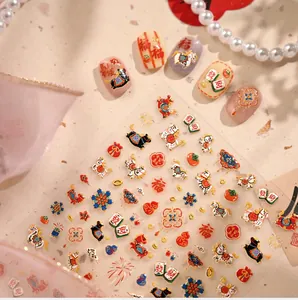 Macro detail of 3D embossed nail stickers featuring traditional Chinese New Year patterns
