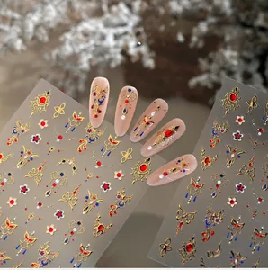 Detail of Chinese phoenix nail decals with gold foil embossed floral patterns on nails