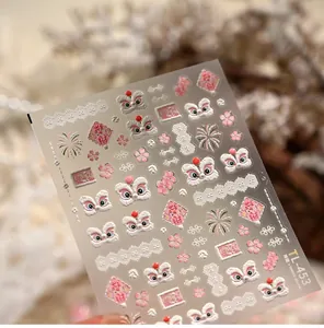 Detail of 3D embossed pink lion dance nail art stickers with gold outlines and lucky charms