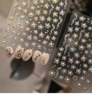 Detail of French luxury nail stickers with silver metal floral outlines and sequins