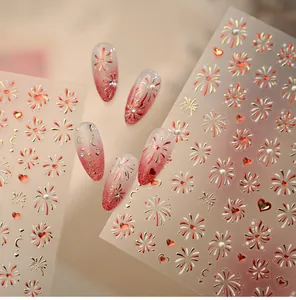 Detailed macro view of 3D embossed gold fireworks and red heart nail art stickers