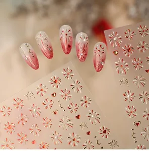 Macro view of festive fireworks and heart nail art stickers on red gradient manicure