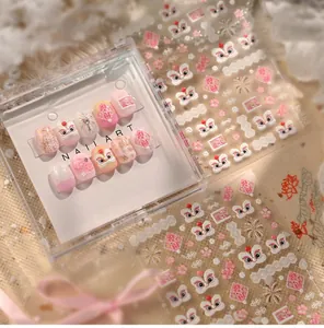 Detail of pink lion dance nail stickers with fireworks patterns and festive motifs
