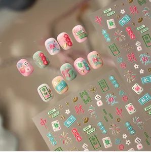 Detail of Mahjong themed nail stickers with gold Chinese characters and festive patterns