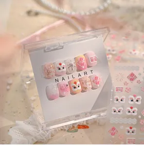 Macro detail of pink lion dance nail stickers and press-on nails with festive patterns