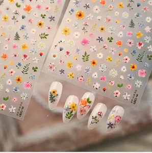 Detailed macro view of M-1381 spring flower nail stickers with gold foil accents