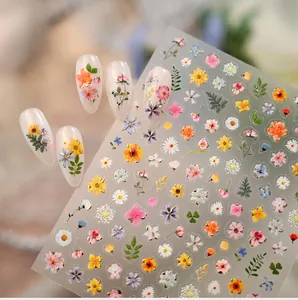 Macro detail of M1381 floral nail stickers with daisy patterns and almond nail samples