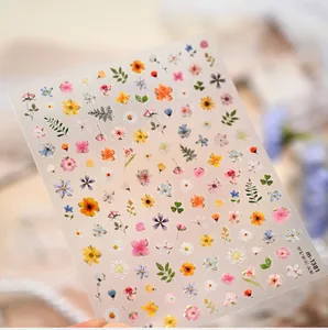 Macro view of M-1381 floral nail stickers with gold foil sunflower and daisy designs