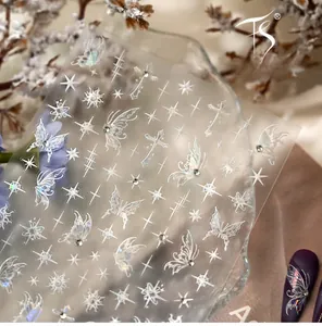 Detailed holographic laser nail art stickers with butterfly and star motifs on a tray