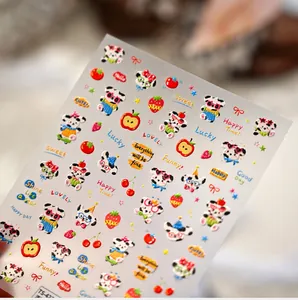 Detail showing 3D embossed cartoon panda and fruit nail art stickers with Lucky text