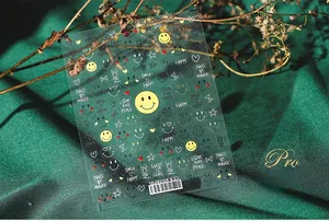 Detailed sheet of 5D embossed nail stickers featuring yellow smiles and lucky girl text