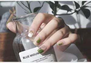 Detailed view of 5D embossed nail stickers featuring gold foil, pearls and abstract faces