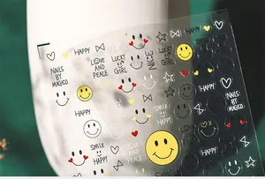 Close-up of 5D embossed nail stickers with yellow smiles and HAPPY typography art