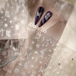 Detailed holographic butterfly and star nail decals with rhinestones on a purple base