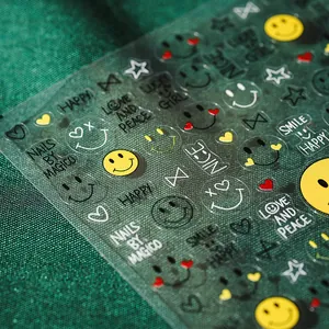5D embossed smiley face nail stickers with stars and hearts on a dark textured background