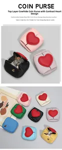 Detail of genuine cowhide mini coin purse with heart decor and pebbled leather texture