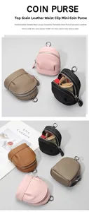 Detailed close-up showing grainy cowhide leather texture and metal zipper of the mini coin bag