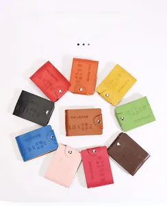 Close-up of colorful leather driver license holders with embossed Chinese text and snap button