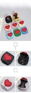 Close-up of mini leather coin purses with red heart patch and metal snap button