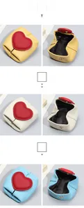 Macro detail of leather mini coin purses with heart buckles in yellow, white, and blue