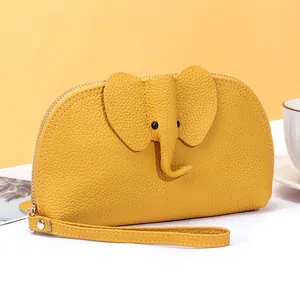 Handmade yellow lychee leather long wallet featuring a 3D elephant design and wrist strap