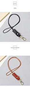 Detail of minimalist leather keychains in black and golden brown with braided rope