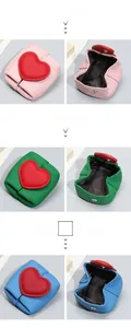 Detail of mini leather coin purses with litchi texture and red heart decoration