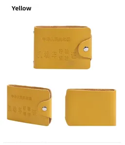 Close-up of yellow leather driving license holder with snap button and debossed text