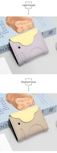 Detail of elephant-shaped leather wallets in light purple and gray with pebble texture