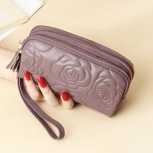 Long leather wallet with three zippers and embossed rose floral pattern in purple