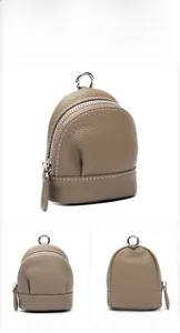 Macro detail of elephant gray pebbled leather coin purse with silver zipper and ring hook