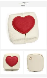 Milkshake white pebbled leather coin purse featuring a red heart patch and gold ring