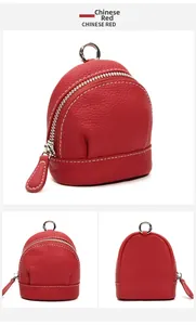 Macro detail of red genuine leather mini coin purse with white stitching and silver hardware