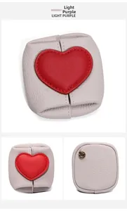 Detail view of light purple leather coin purse with red heart and gold clip
