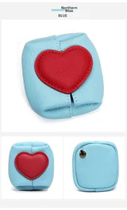 Detailed views of the blue lychee grain leather coin purse with red heart patch and metal ring