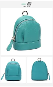 Three perspectives of a lake blue leather mini coin purse with silver zipper and white stitching