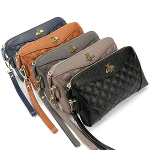 Quilted leather wristlet clutches with gold bee accents in five assorted colors