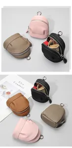 Detail showing the inner storage of mini leather backpack coin purses with zipper closure