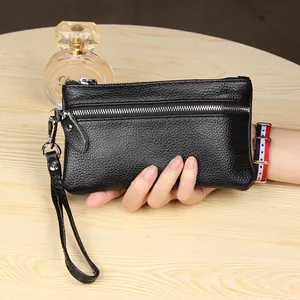 Slim black genuine leather clutch bag with pebble texture and detachable wristlet strap
