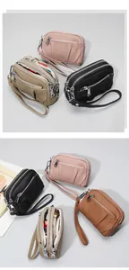 Detail of genuine leather coin purse showing three zippers and lychee texture
