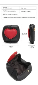 Macro detail of genuine leather coin purse with heart patch and metal snap closure