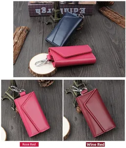 Detail of leather key pouches in Navy Blue, Rose Red, and Wine Red with metal hooks