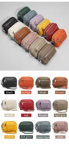 Detail of multi-layer zipper coin purses in twelve colors with genuine lychee leather texture