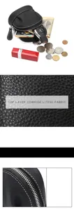 Macro detail of litchi grain cowhide leather and contrast stitching on black coin purse