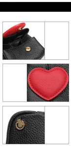 Detail of black pebble leather mini coin purse with red heart and gold snap fastener