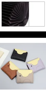 Detail of multi-slot leather elephant card holder with colorful accordion fold interior