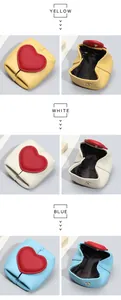 Detailed view of mini leather coin purses with heart flap in yellow, white and blue