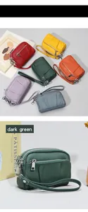 Close-up of multicolored leather coin purses with three zippers and detachable wrist strap